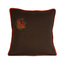 Load image into Gallery viewer, Hand embroidered orangutan with leaves surrounding him, on a dark olive linen cushion with burnt orange binding.