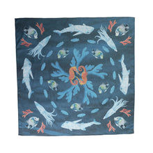 Load image into Gallery viewer, A square scarf in a blue colour with sea creatures making a circular pattern like they are synchronised swimming. Orange seahorses, blue and white squids, whale sharks, fish with a little bit of yellow, and blue and orange coral.