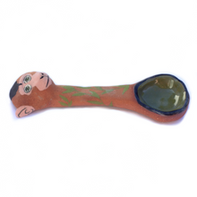 Load image into Gallery viewer, Side view of a ceramic spoon with a sculptered monkey head and leaves painted on the spoon body.
