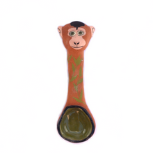 Load image into Gallery viewer, Ceramic spoon with a sculptered monkey head at the top and leaves painted on the spoon body.