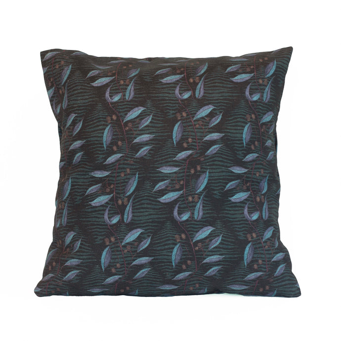 Organic cotton cushion cover with brown gum nuts and gum leaves that are half blue and purple in colour, tasmanian tiger stripes in green, on a dark coloured background. 