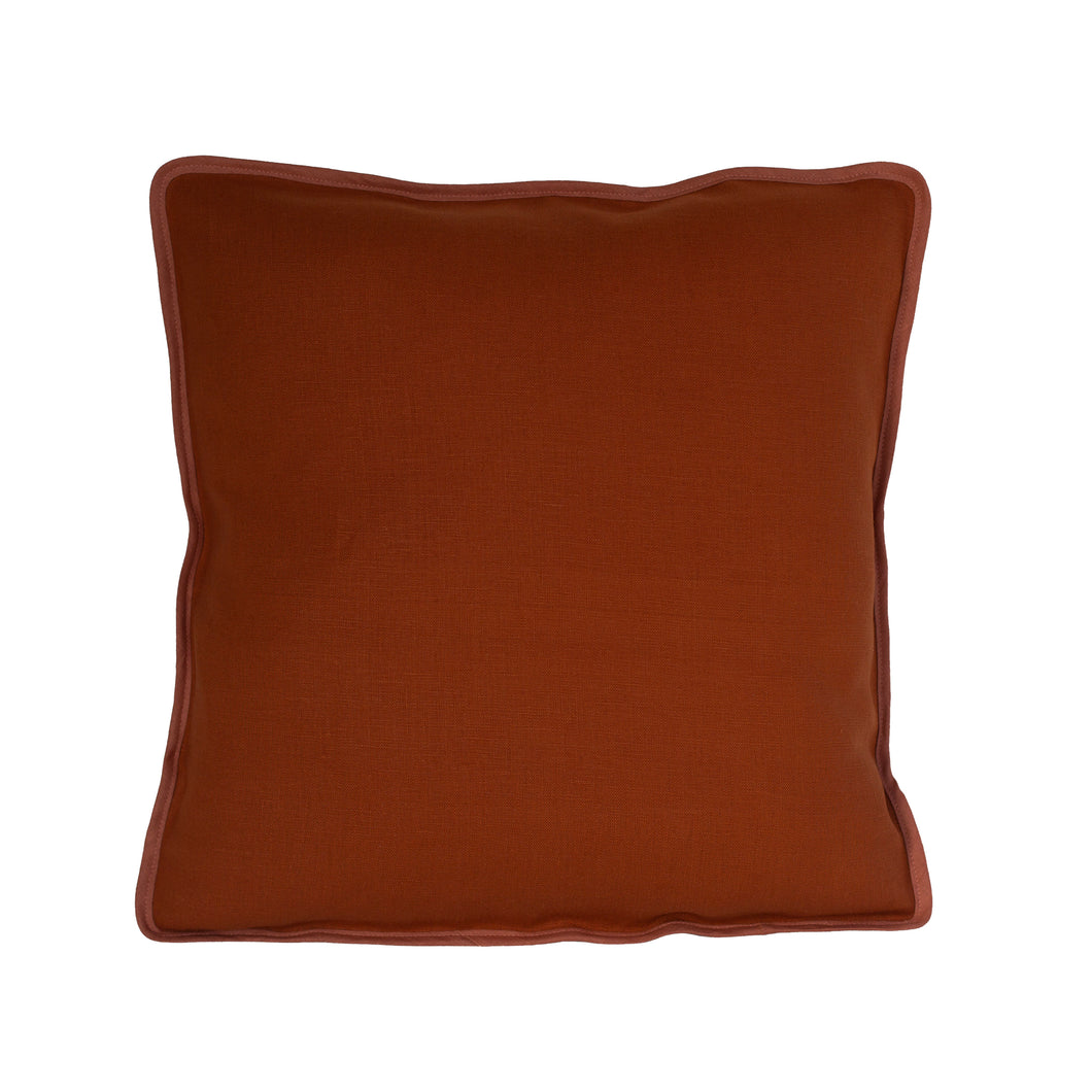 Burnt orange linen cushion with a complimentary vintage coloured pink binding. 