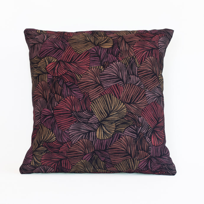 Organic cotton cushion cover with a repeated fan palm leaf pattern in orange, red, purple, mauve and yellow colours with a black outline.