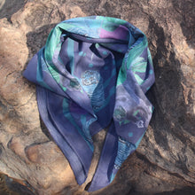 Load image into Gallery viewer, Scarf with Sun bear and tiger design displayed on a large rock.
