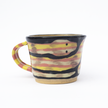 Load image into Gallery viewer, Handmade ceramic mug with a pink and yellow striped handle and an illustration of a pink, yellow and white striped snake.
