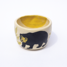 Load image into Gallery viewer, Top view of handmade ceramic cup with illustration of sun bear, leaves and a sun inside the cup.
